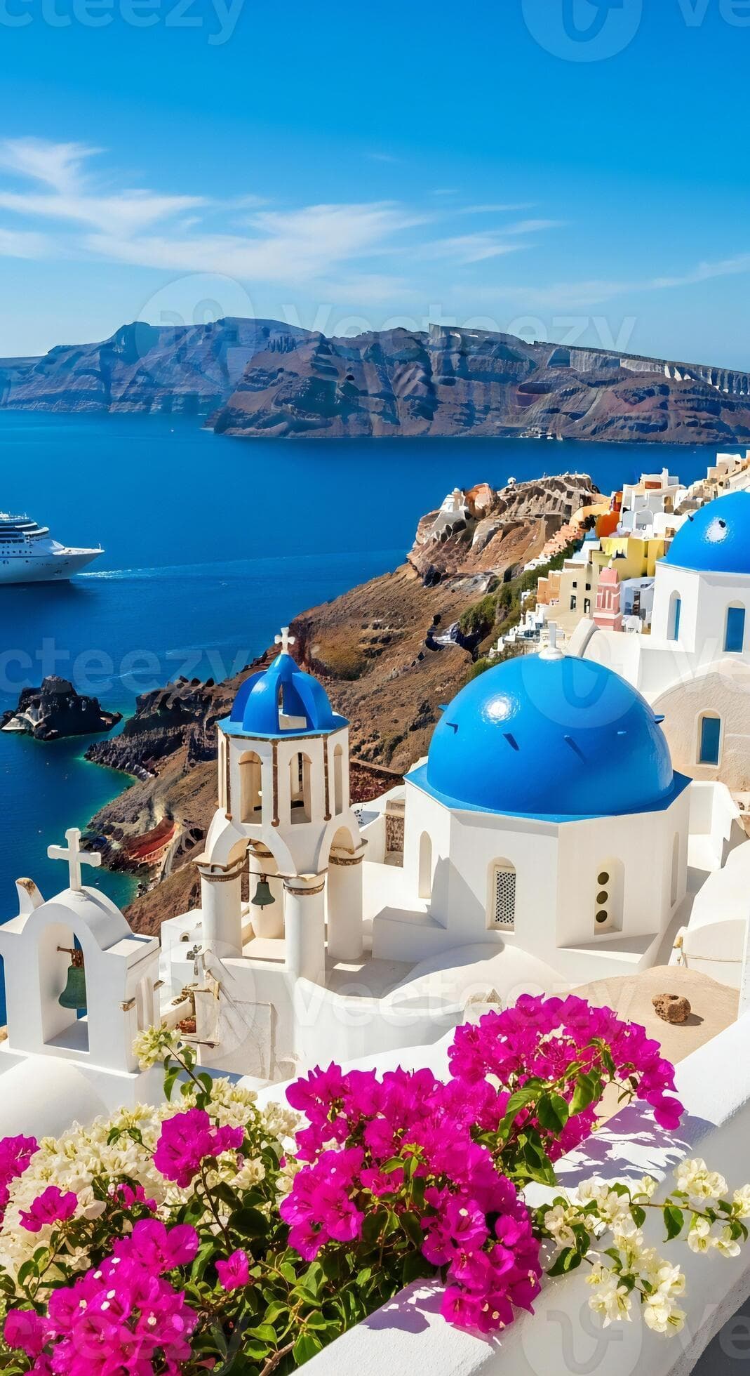 Whitewashed village with blue domed churches overlooking the sea and mountains bright flowers in foreground