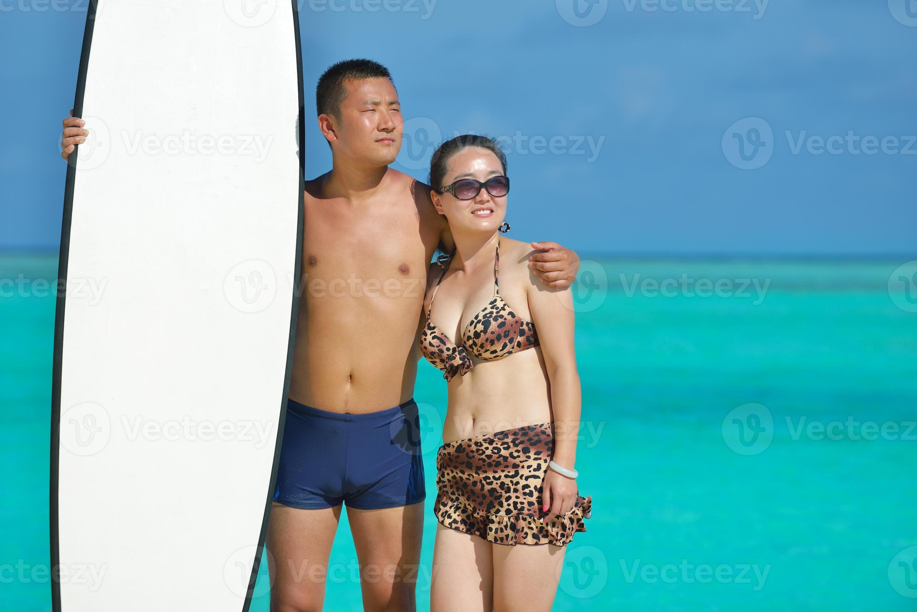 happy young couple enjoying summer on beach